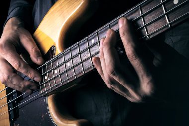 Singing and playing bass guitar